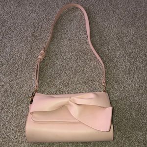 Light pink crossbody purse with bow on front